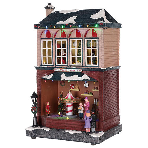 Casa di Natale con giostrina e Babbo Natale 45x25x20 cm 3