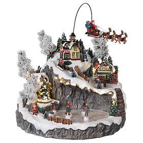 Christmas village with Santa's sleigh ice skaters mouvement lights and music 40x45x35 cm