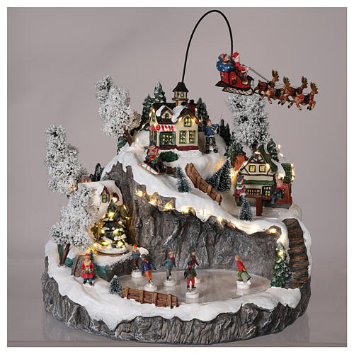 Christmas village with Santa's sleigh ice skaters mouvement lights and music 40x45x35 cm 2