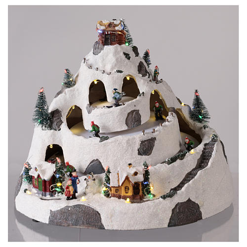 Mountain Christmas village with skiers moving 30x30x25 cm 2
