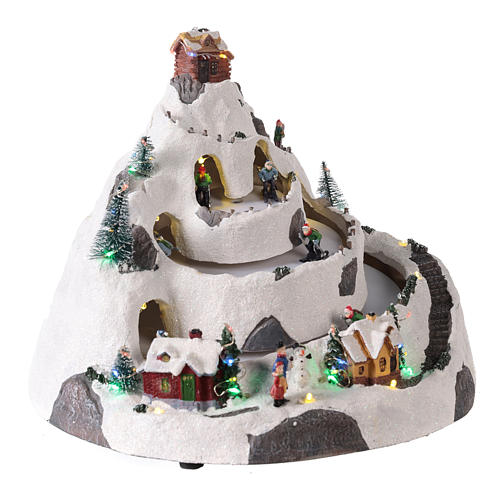 Mountain Christmas village with skiers moving 30x30x25 cm 4