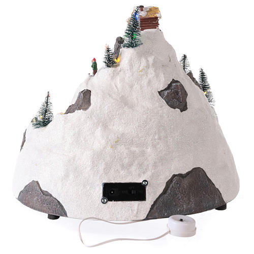 Mountain Christmas village with skiers moving 30x30x25 cm 5