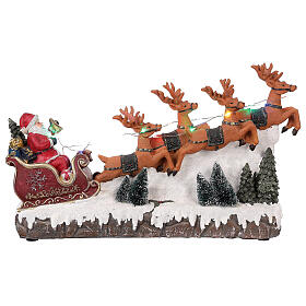 Pueblo navideño trineo de Papá Noel renos luz música 25x40x10