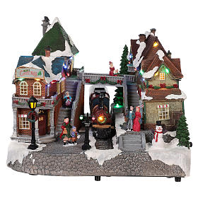 Pueblo navideño estación de trenes movimiento luz música 25x35x25
