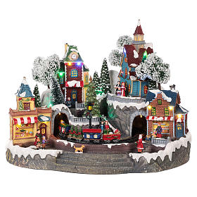 Village Noël train et magasins mouvement lumière musique 35x45x35 cm