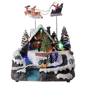 Aldeia de Natal em miniatura com riacho e o Pai Natal no trenó, luzes e música, 24x21x20 cm