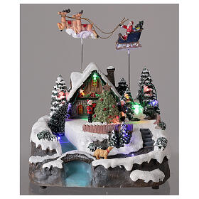 Aldeia de Natal em miniatura com riacho e o Pai Natal no trenó, luzes e música, 24x21x20 cm