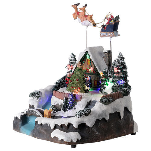 Aldeia de Natal em miniatura com riacho e o Pai Natal no trenó, luzes e música, 24x21x20 cm 3