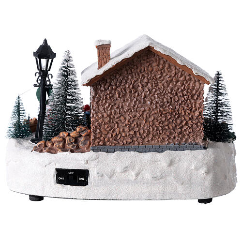 Pueblo navideño Papá Noel y hoguera luces música 25x15x20 cm 5