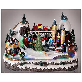 Christmas village 20x35x25 cm animated Christmas tree and skaters, batteries or electricity