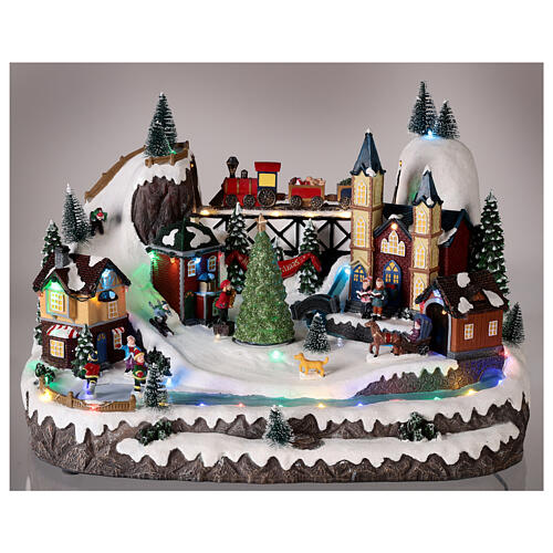 Christmas village 20x35x25 cm animated Christmas tree and skaters, batteries or electricity 2