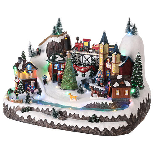 Christmas village 20x35x25 cm animated Christmas tree and skaters, batteries or electricity 3