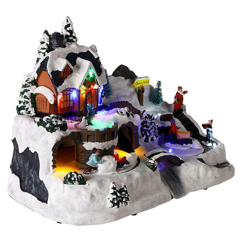 Christmas village with children in motion, LED lights, 25x35x20 cm 4
