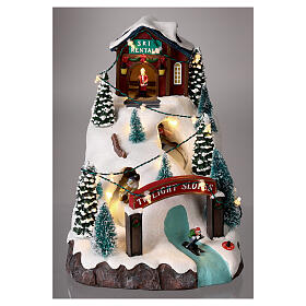 Christmas village, mountain with skiers, animation and LED light, 20x15x25 cm