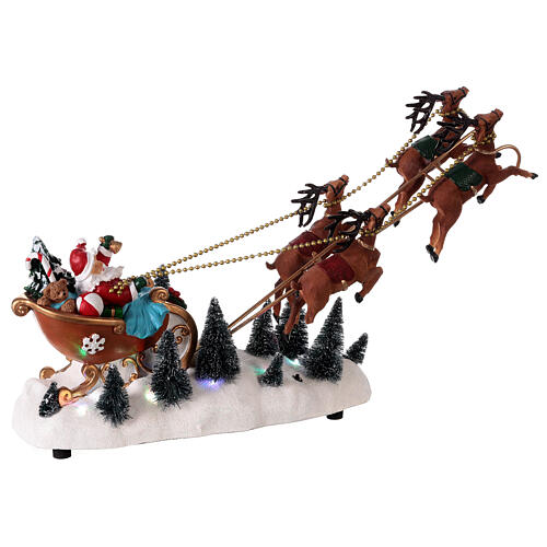 Traîneau Père Noël neige rennes volantes lumières LED 35x45x15 cm