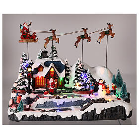 Snowy Christmas village with Santa sleigh animated LED lights 30x35x18 cm