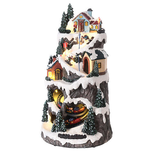 Snowy mountain village with train in motion, LED lights, 40x20x20 cm 3