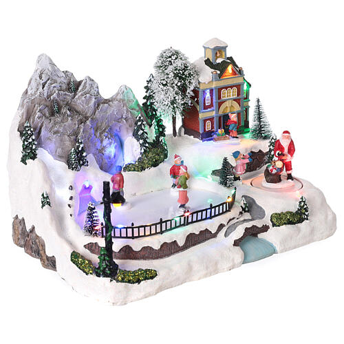 Christmas village with moving characters and LED lights 20x30x20 cm 4