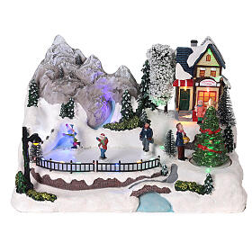 Scena natalizia neve pattinatori movimento luci led 20x30x20 cm