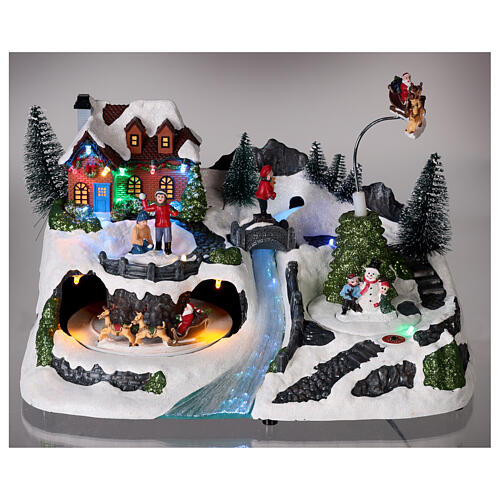 Scène Noël neige traîneau Père Noël animé lumières LED 20x30x15 cm