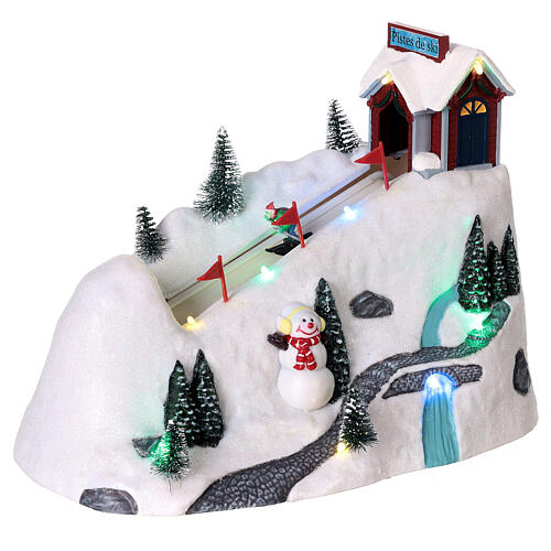 Pueblo navidad nieve montaña esquiadores movimiento luces led 20x30x15 cm 3