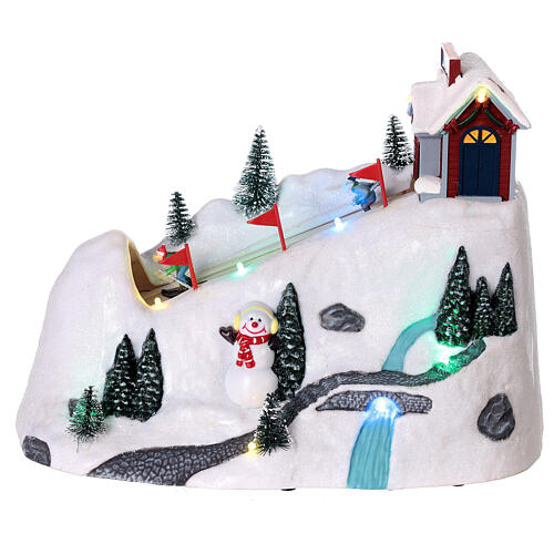 Villaggio natale neve montagna sciatori movimento luci led 20x30x15 cm 1