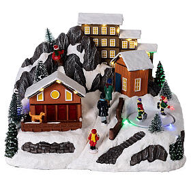 Pueblo Navidad nieve patinadores movimiento luces led 20x30x20 cm