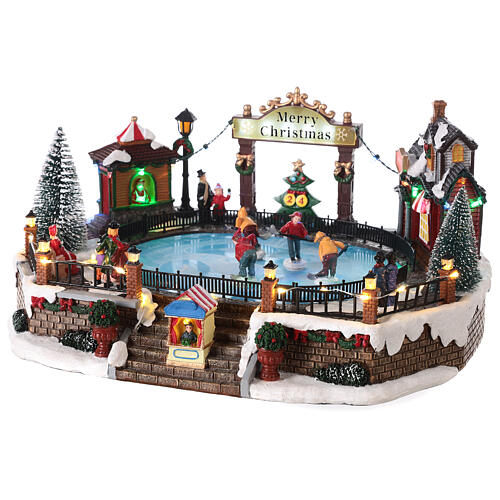 Christmas set with ice rink and skaters in motion, LED lights, 20x30x25 cm 3