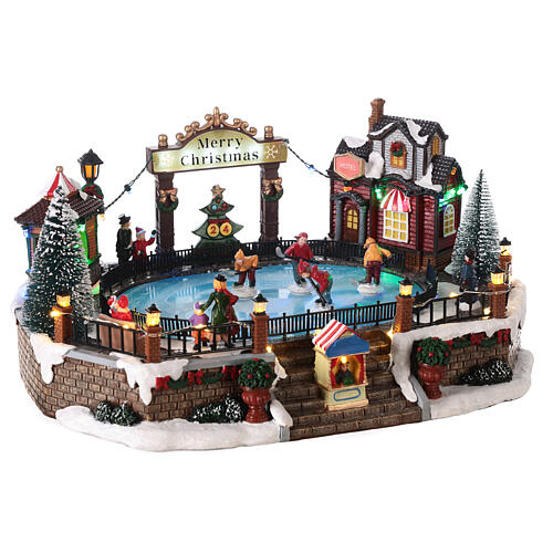 Christmas set with ice rink and skaters in motion, LED lights, 20x30x25 cm 4