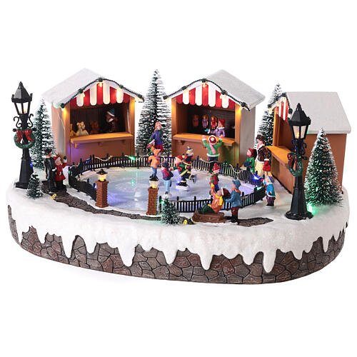 Christmas village with ice rink and figurines in motion, LED lights, 15x35x25 cm 3