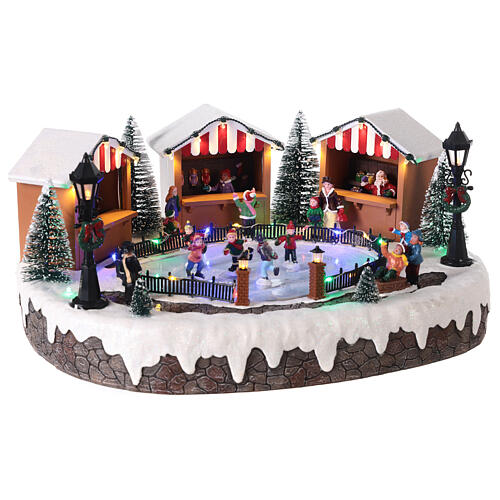Christmas village with ice rink and figurines in motion, LED lights, 15x35x25 cm 4