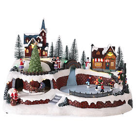 Christmas village set with snow and skaters in motion, LED lights, 25x40x25 cm