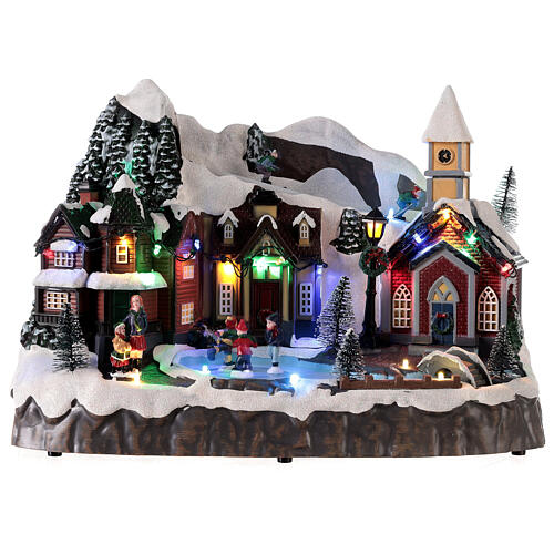 Snowy Christmas village with animated skiers skaters LED lights 25x30x20 cm 1