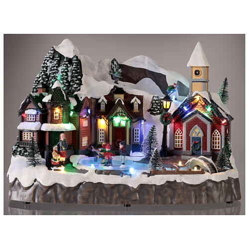 Snowy Christmas village with animated skiers skaters LED lights 25x30x20 cm 2
