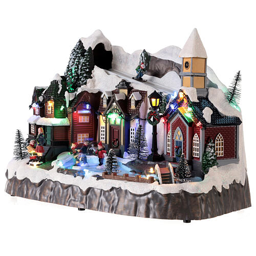 Snowy Christmas village with animated skiers skaters LED lights 25x30x20 cm 3