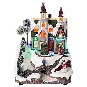 Village Noël neige église sapin en mouvement lumières LED 30x20x20 cm