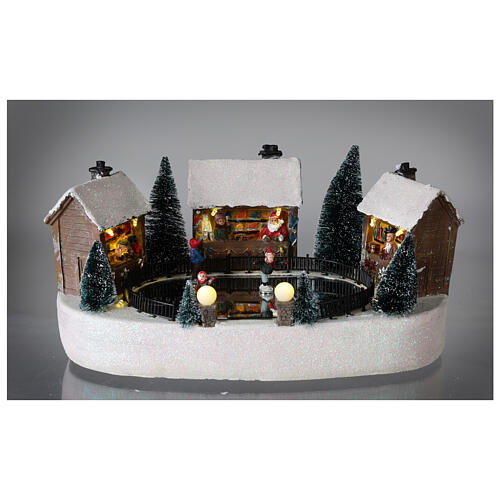 Cenário natalino pista de gelo com casas movimento música luzes LED 15x30x20 cm pilhas 2