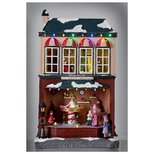 Miasteczko bożonarodzeniowe dom z ruchomą karuzelą, melodią i LED, 40x25x20 cm zasilane z sieci elektrycznej 2