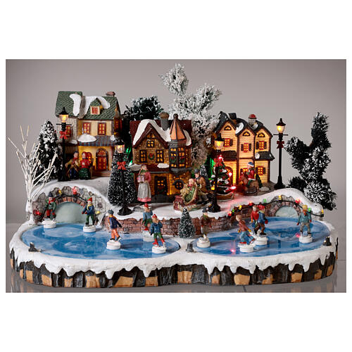 Christmas village set: ice rink with skaters in motion 20x40x35 cm 2