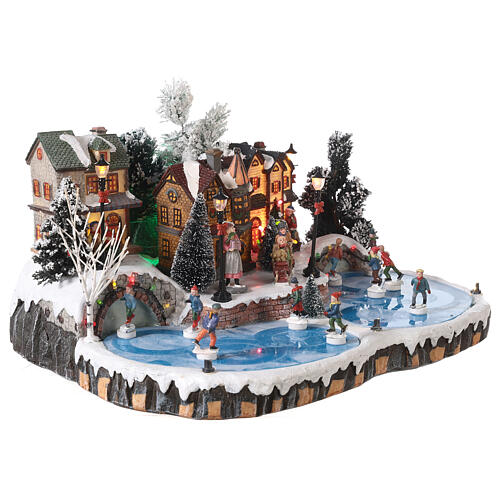 Christmas village set: ice rink with skaters in motion 20x40x35 cm 4