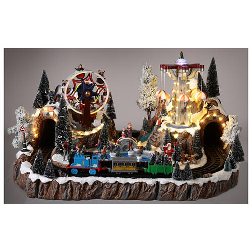 Christmas village set with train in motion, amusement park and skaters 40x70x50 cm 2