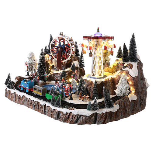 Christmas village set with train in motion, amusement park and skaters 40x70x50 cm 3