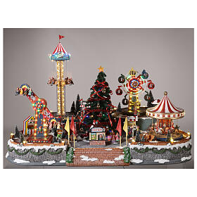Pueblo navideño con luces, árbol de Navidad, parque de atracciones, tiovivos 60x90x60 cm