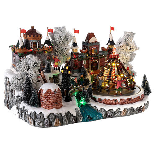 Christmas village: decorated merry-go-round, castle and sleigh ramp, motion lights and music, 25x35x25 cm 3