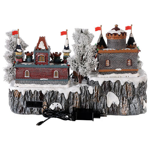 Christmas village: decorated merry-go-round, castle and sleigh ramp, motion lights and music, 25x35x25 cm 5