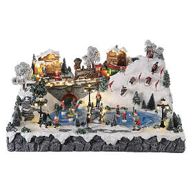 Christmas village: mountain with ice skaters, ski slope and train, motion lights and music, 30x60x50 cm