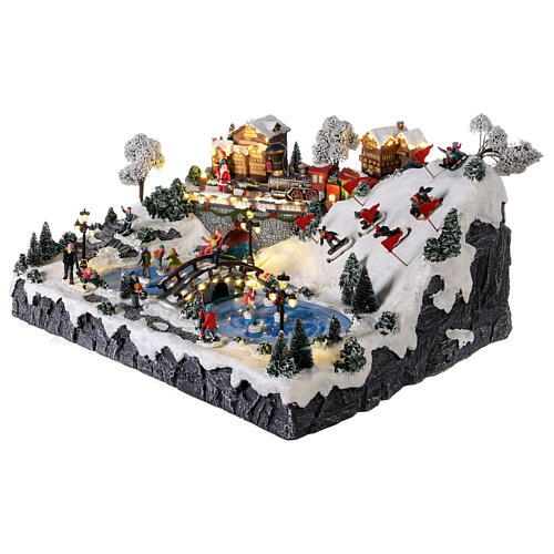 Christmas village: mountain with ice skaters, ski slope and train, motion lights and music, 30x60x50 cm 3