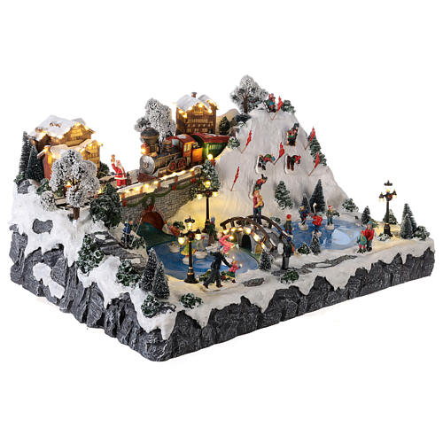 Christmas village: mountain with ice skaters, ski slope and train, motion lights and music, 30x60x50 cm 4