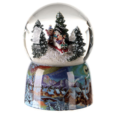 Musical Christmas snow globe sled with children 15x10x10 1