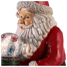 Santa with nutcracker snow globe 10x5x6 in